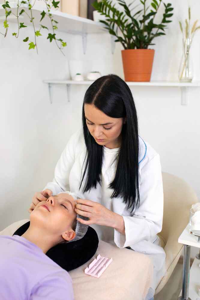 A dermatologist at Revive Skin and Cosmetology Clinic in Palakkad provides treatment to a patient, showcasing a professional and caring environment focused on skin health.