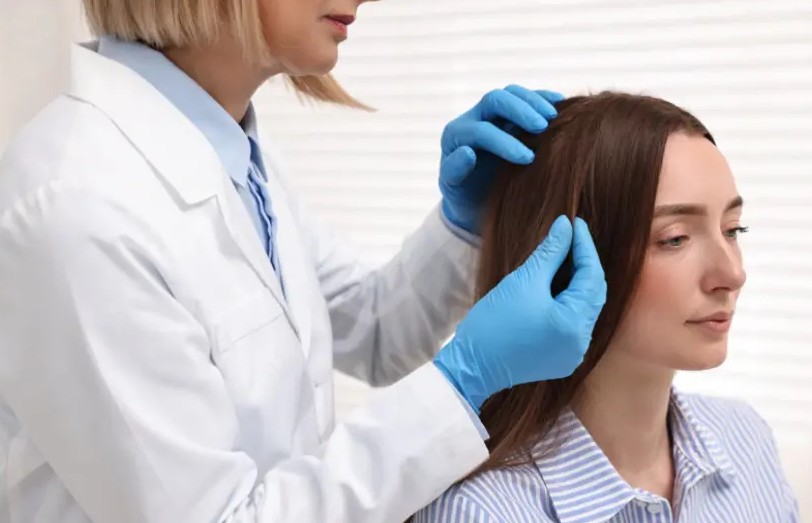 Dermatologist examining a female patient’s scalp and hair condition during a consultation for hair fall concerns — When-Should-You-Consult-a-Dermatologist-for-Hair-Fall